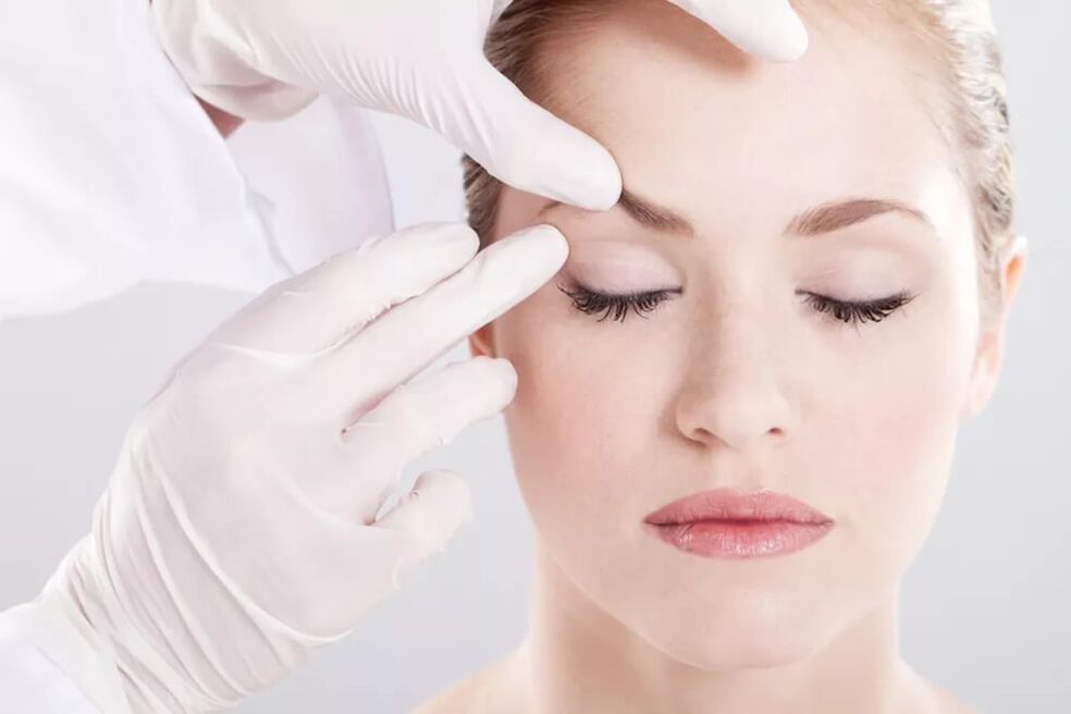 Beautician checks skin around eyes